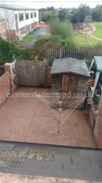 Courtyard with storage shed containing a freezer and tumble dryer 